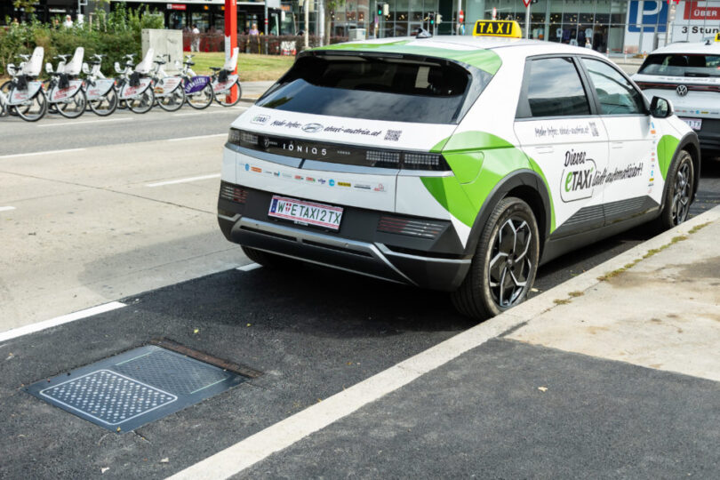 Parkendes E-Taxi des Projektes bei Matrix Ladestation in städtischem Gebiet.
